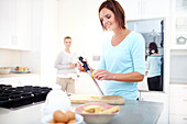 Woman zesting lemon in kitchen