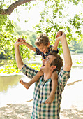 Playful father carrying son