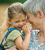 Grandmother and granddaughter hugging