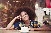 Woman with afro drinking coffee