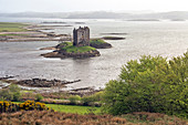 View of island castle on lake, Scotland