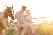 Couple walking with horse