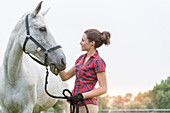 Woman feeding horse