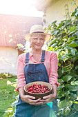 Woman holding harvested cherries