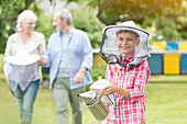 Portrait smiling boy in beekeeper hat