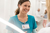 Smiling nurse talking to doctor