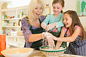 Grandmother and granddaughters baking