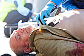 Rescue worker using defibrillator