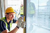 Construction worker measuring window
