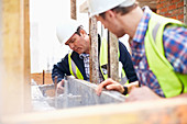 Construction workers examining structure