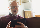 Senior man using digital tablet