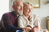 Smiling senior couple hugging and