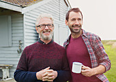 Father and son drinking coffee outside