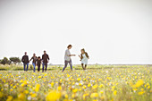 Family walking in meadow with wildflowers