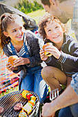 Family eating hamburgers at barbecue