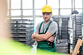Worker with arms crossed in factory