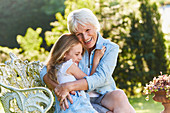 Grandmother and granddaughter hugging