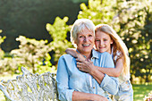 Grandmother and granddaughter hugging