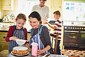 Family baking cake in kitchen