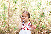 Toddler girl talking on cell phone