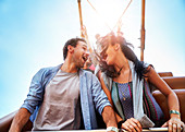 Exhilarated couple on amusement park ride