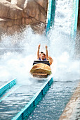 Man riding water log amusement park ride
