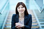 Businesswoman sitting on stairs