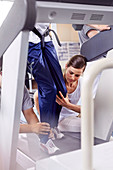 Physiotherapists guiding man on treadmill