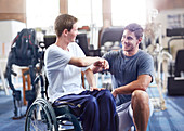 Physiotherapist and man in wheelchair