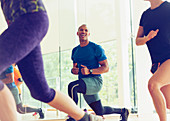 Smiling man lunging in exercise class