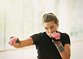 Woman with exercise gloves shadow boxing