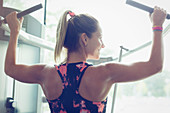 Woman doing lat pulldowns on equipment