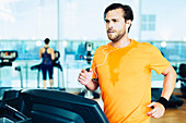 Sweating man running on treadmill
