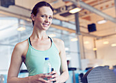 Woman drinking water at gym