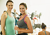 Portrait smiling women resting at gym