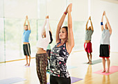 Yoga class with arms raised