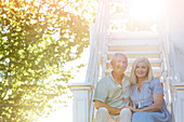 Senior couple sitting on summer stairs