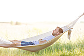 Young man sleeping in summer hammock