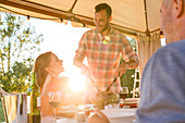 Man serving salad to wife