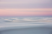 Sunset over tranquil white sand dune