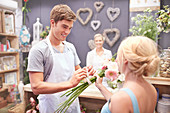 Florist tying flowers for woman
