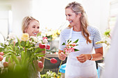 Laughing florists arranging bouquet