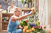 Woman picking out flowers in flower shop