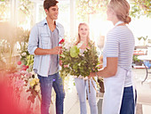Florist helping customers select flowers