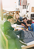 College students studying on bed