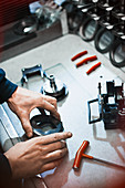 Worker examining part in steel factory