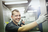 Portrait smiling worker in steel factory