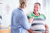 Doctor comforting senior man at checkup