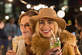 Women drinking cocktails at party
