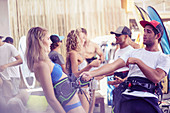 Man teaching woman kiteboarding technique